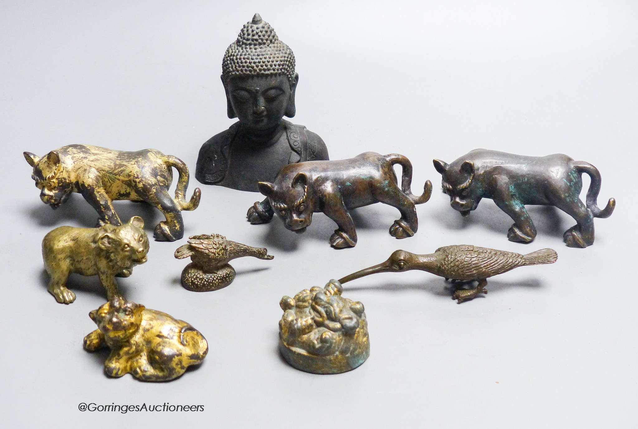 A group of nine Chinese and Oriental bronze figures to include five Han Dynasty style bronzes, tallest 12cm